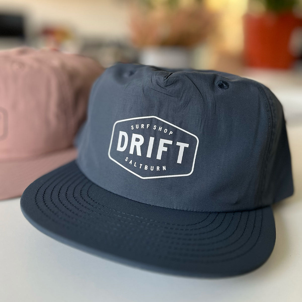 Surf cap in blue printed with a brand logo