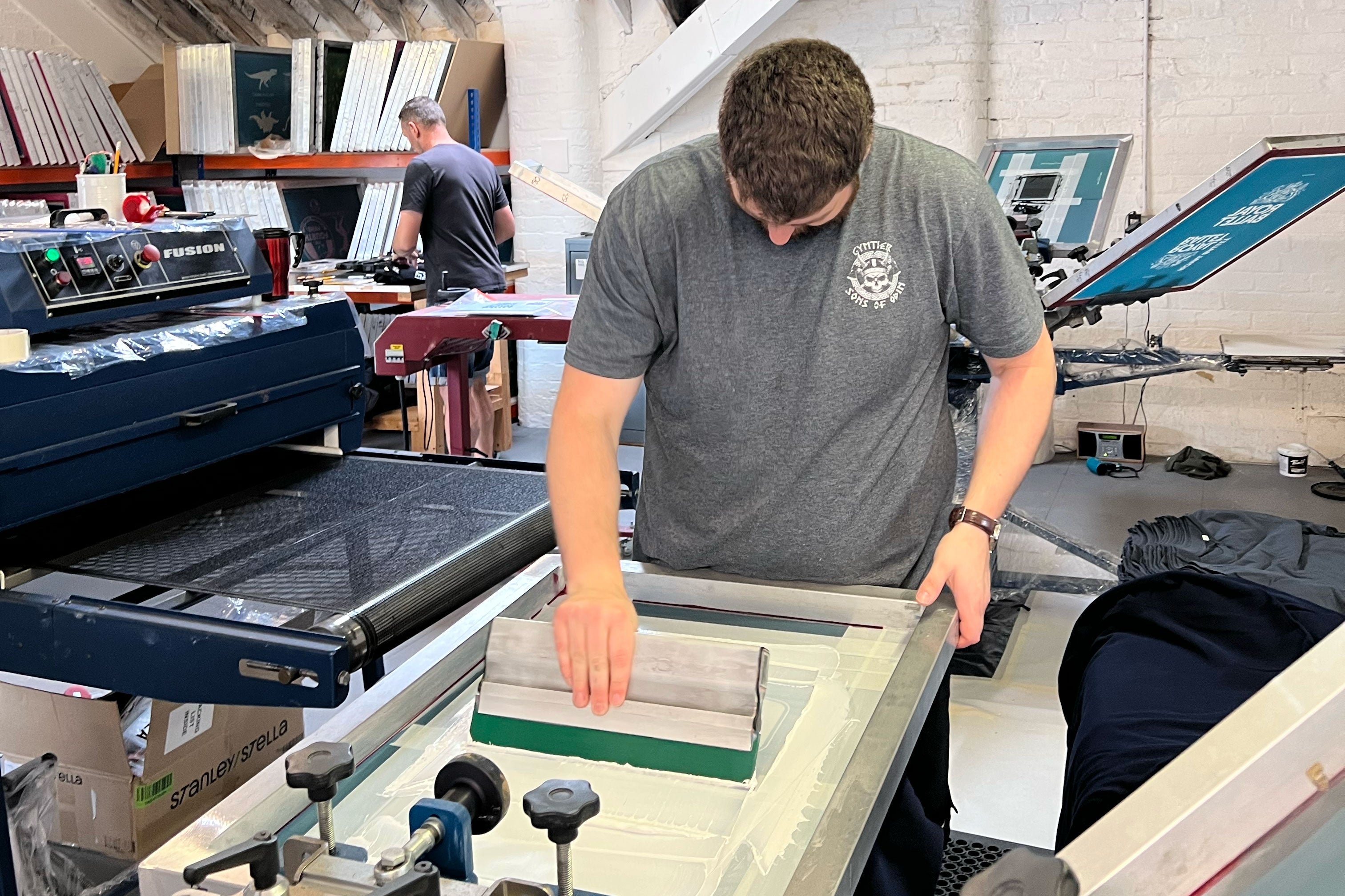 View of printers screenprinting t-shirts in Huddersfield Studio