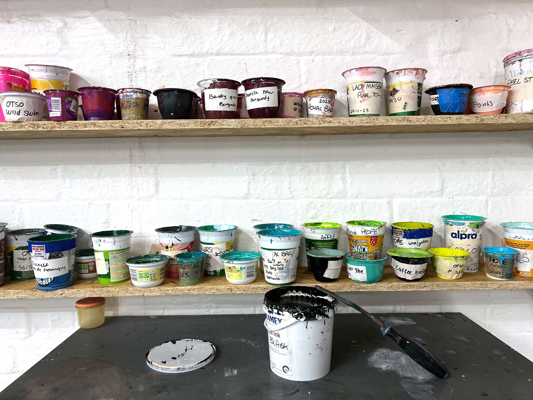 Pots of Screenprinting ink on studio shelf